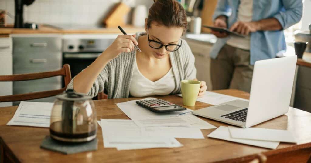 woman drinking coffee and preparing budget