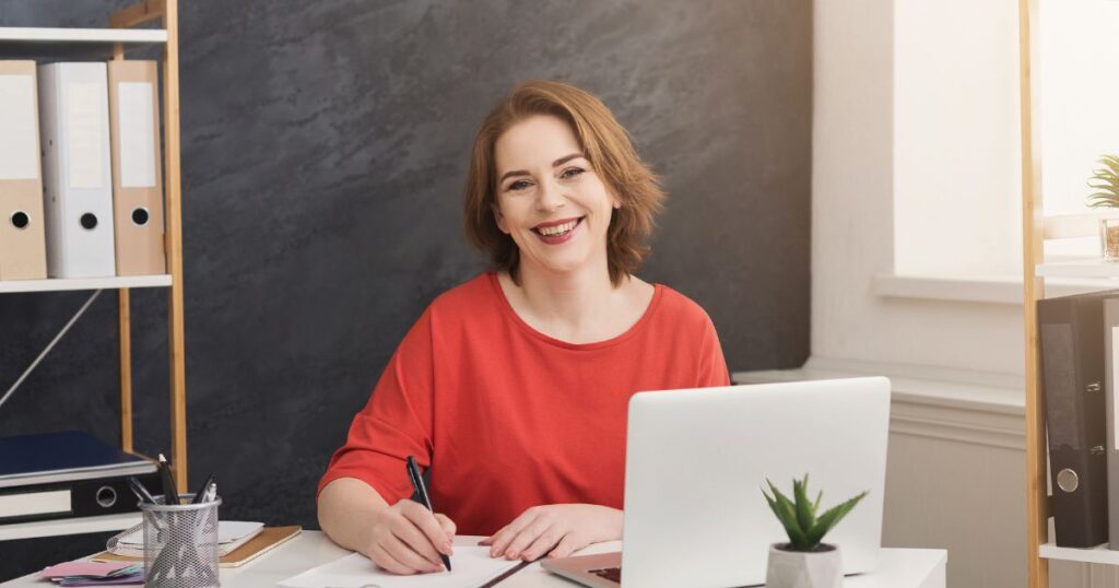 happy woman working on laptop
