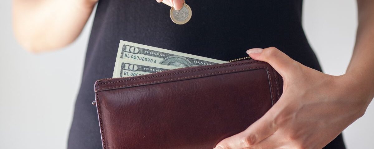 What Is Cash Stuffing? The Simple Way to Take Control of Your Spending 2 putting money in purse