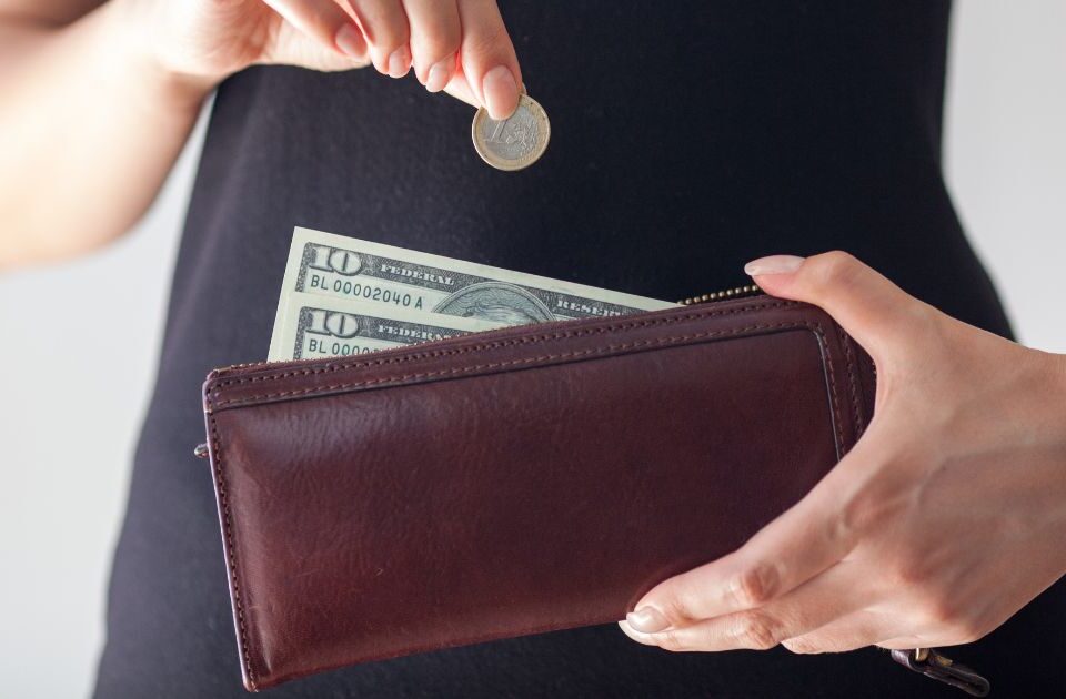 What Is Cash Stuffing? The Simple Way to Take Control of Your Spending 16 putting money in purse